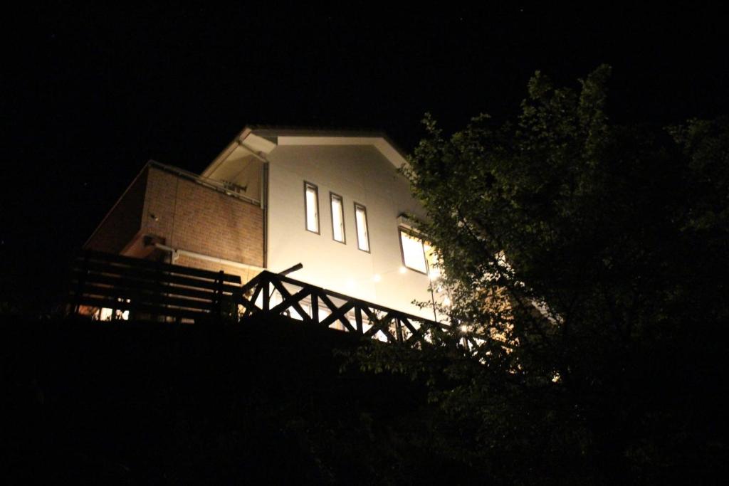 a white house at night with its lights on at Sumoto - House - Vacation STAY 91396 in Sumoto