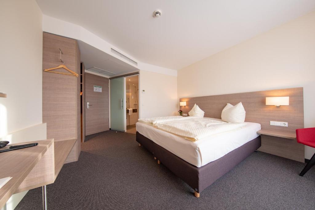 Postel nebo postele na pokoji v ubytování Hotel Susato