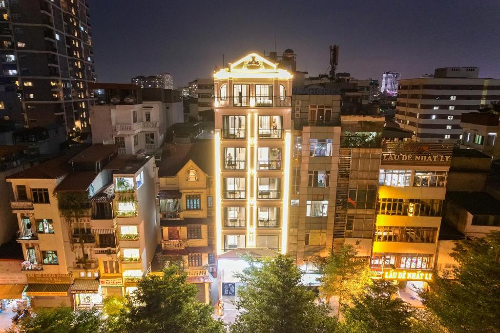 a tall building with its lights on at night at 22housing Residence Suites in Hanoi