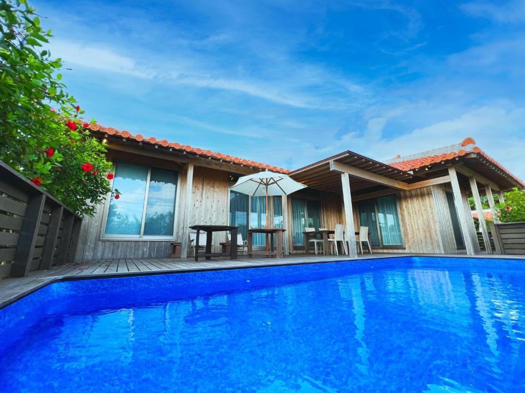 a villa with a swimming pool and a house at Villa Muse Okinawa- Vacation STAY 43786v in Nago