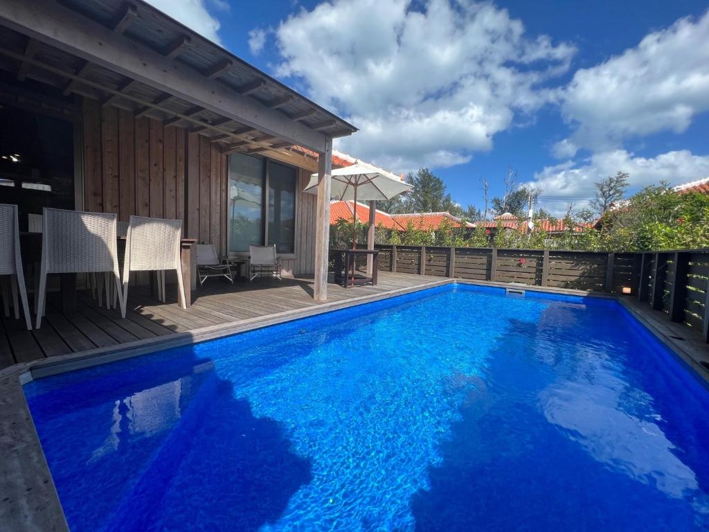 a swimming pool with blue water in a house at Villa Muse Okinawa- Vacation STAY 43823v in Nago