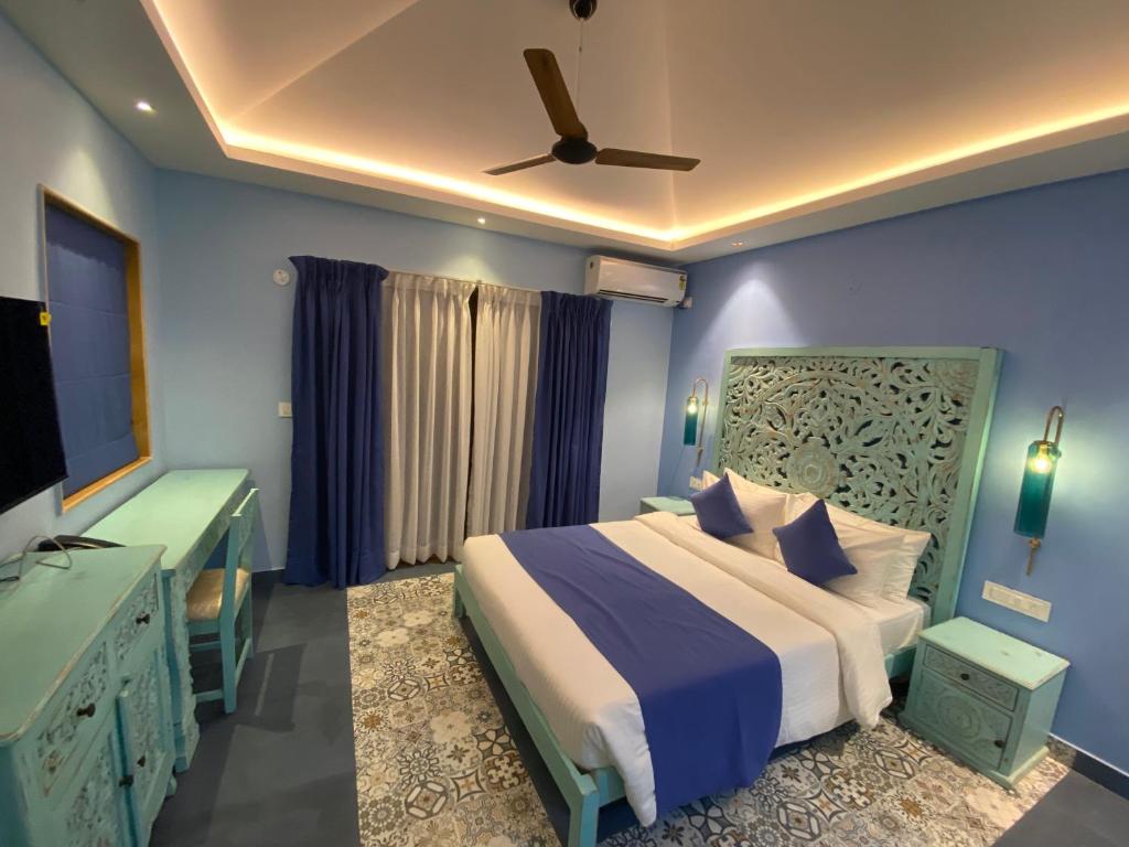 1 dormitorio con 1 cama y ventilador de techo en Atmani waterfront resort, en Cola