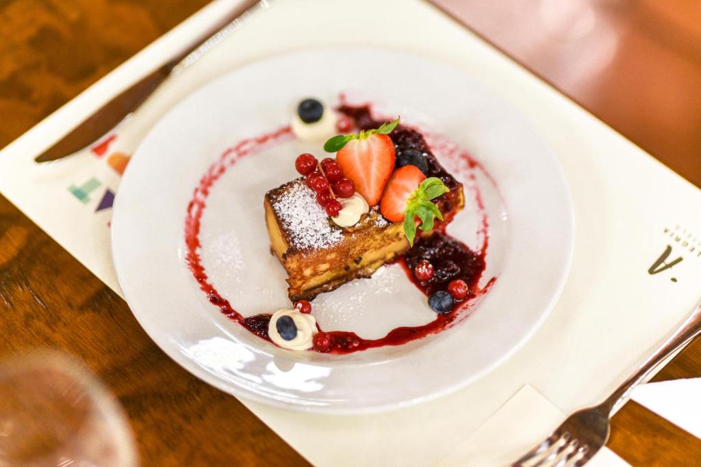 a plate of dessert with fruit on a table at ALEGRIA Bodega Real in El Puerto de Santa María