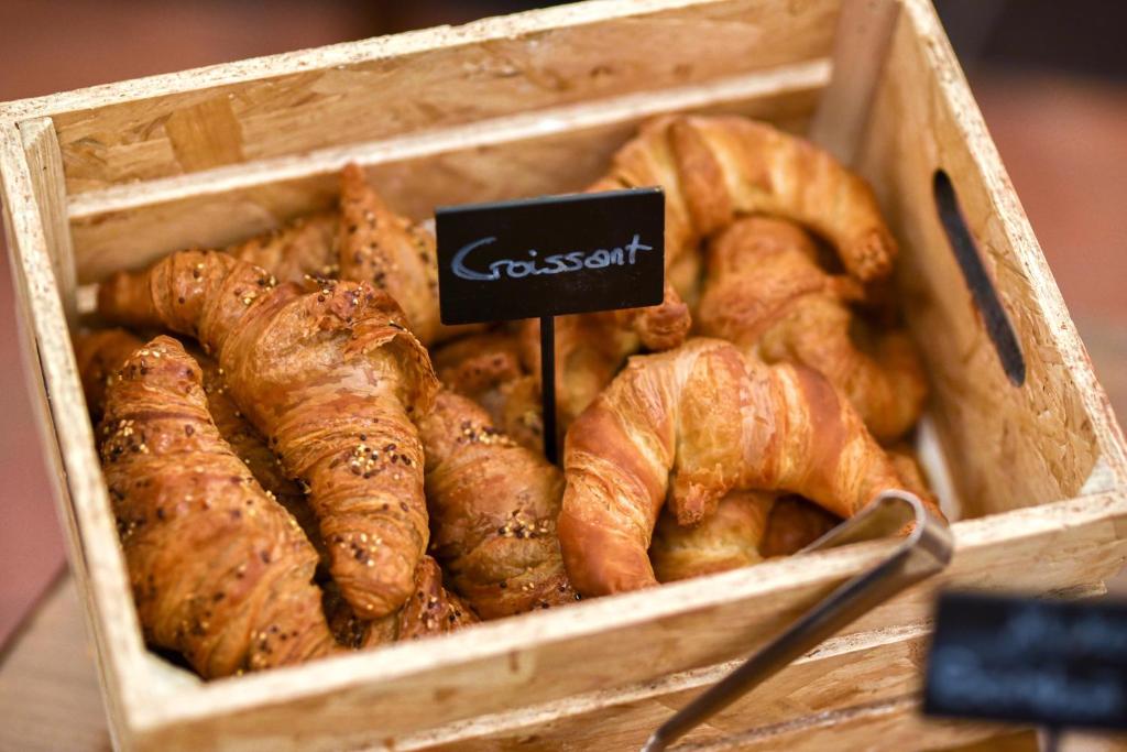 a wooden box filled with croissants and pastries at ALEGRIA Bodega Real in El Puerto de Santa María