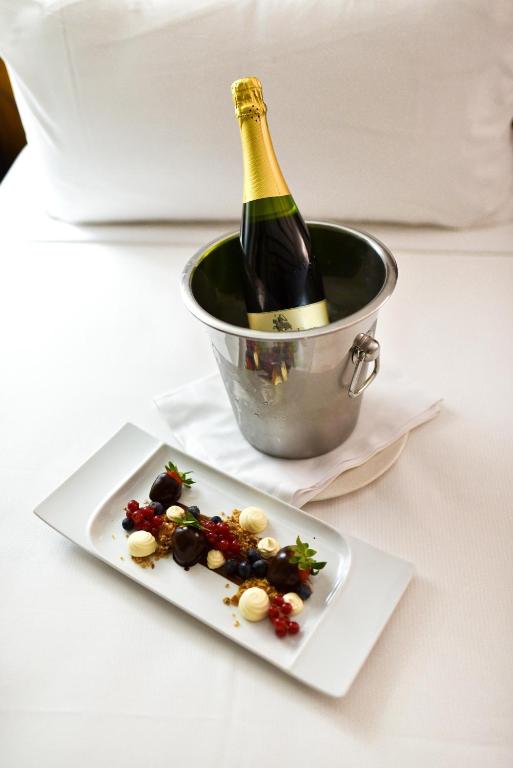 a bottle of champagne and a plate of food at ALEGRIA Bodega Real in El Puerto de Santa María