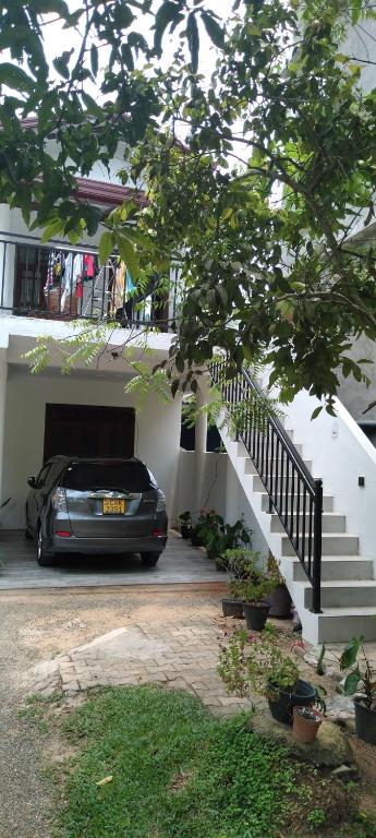 a car parked in front of a house with a staircase at Villa 142 in Weligama