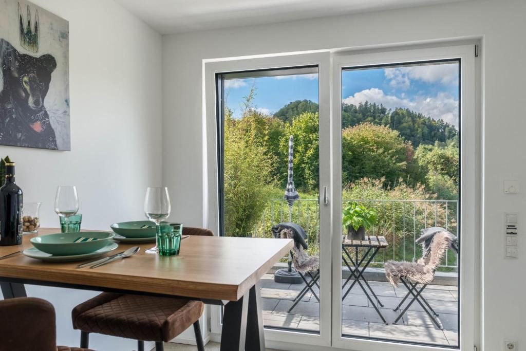 a dining room with a sliding glass door leading to a patio at Landtraum 17 in Deggenhausertal