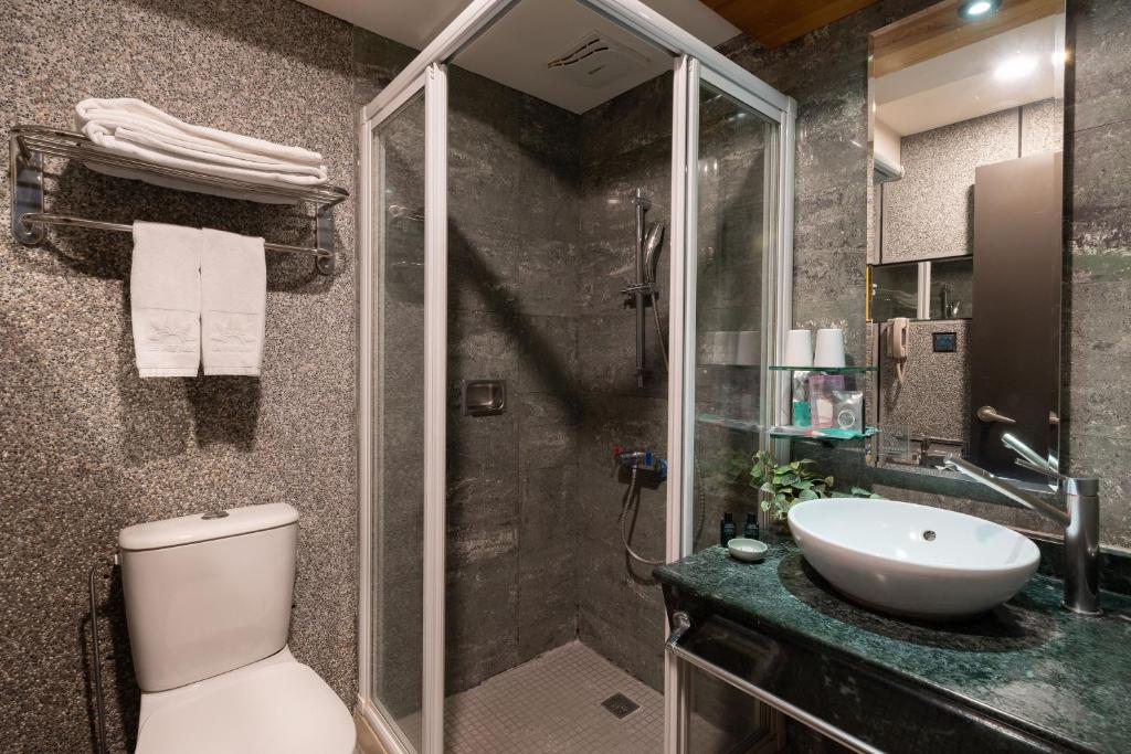 a bathroom with a shower and a toilet and a sink at CHECK inn Express Taichung Fengchia in Taichung