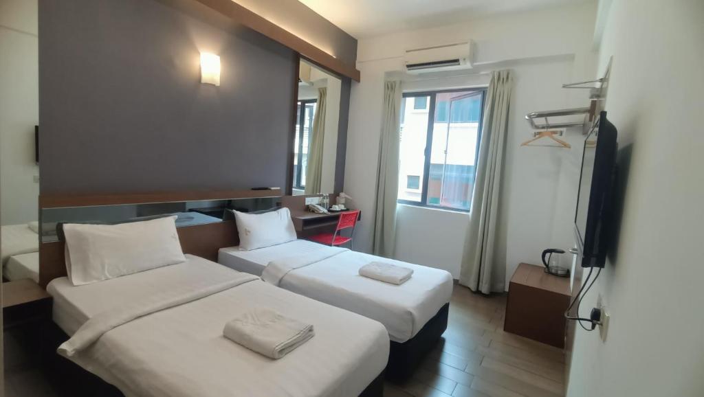 Postel nebo postele na pokoji v ubytování Hotel Golden View Nilai