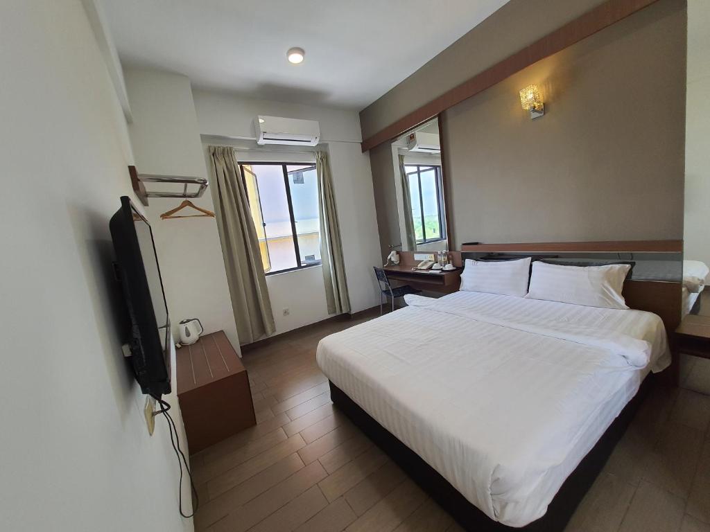 Postel nebo postele na pokoji v ubytování Hotel Golden View Nilai
