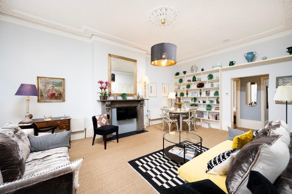a living room with a couch and a table at Charming Apartment in the Heart of Camden in London