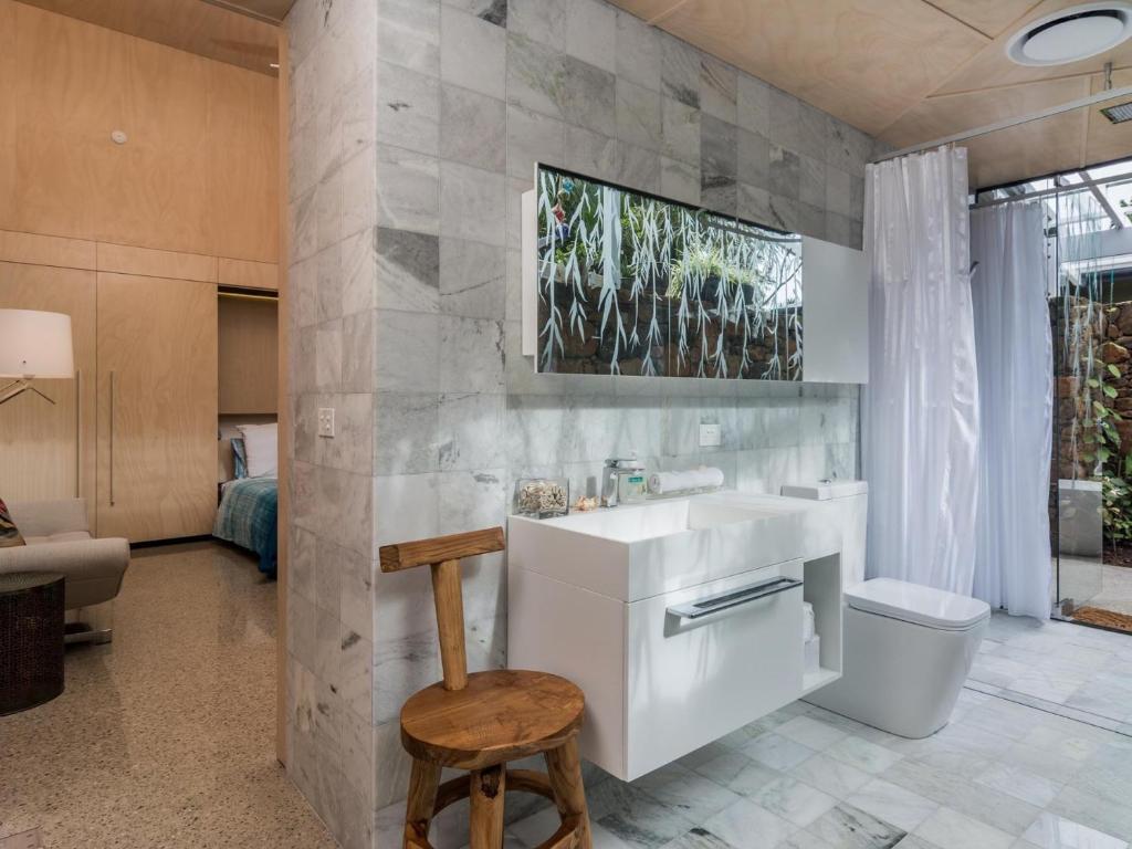 a bathroom with a sink and a toilet at Buhwi Bira Byron Bay - Studio in Byron Bay