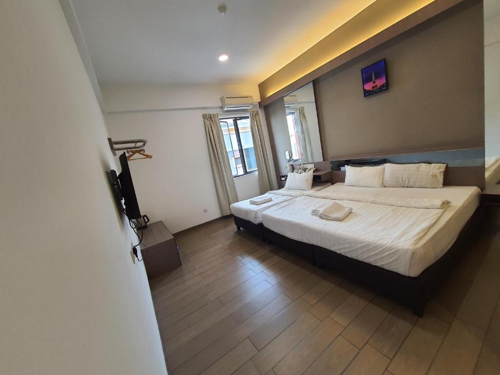 Postel nebo postele na pokoji v ubytování Hotel Golden View Nilai