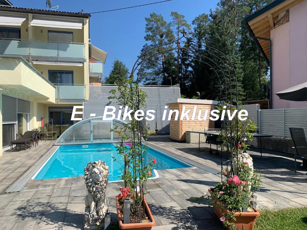 a swimming pool in front of a house at enJoy Appartements in Sankt Kanzian