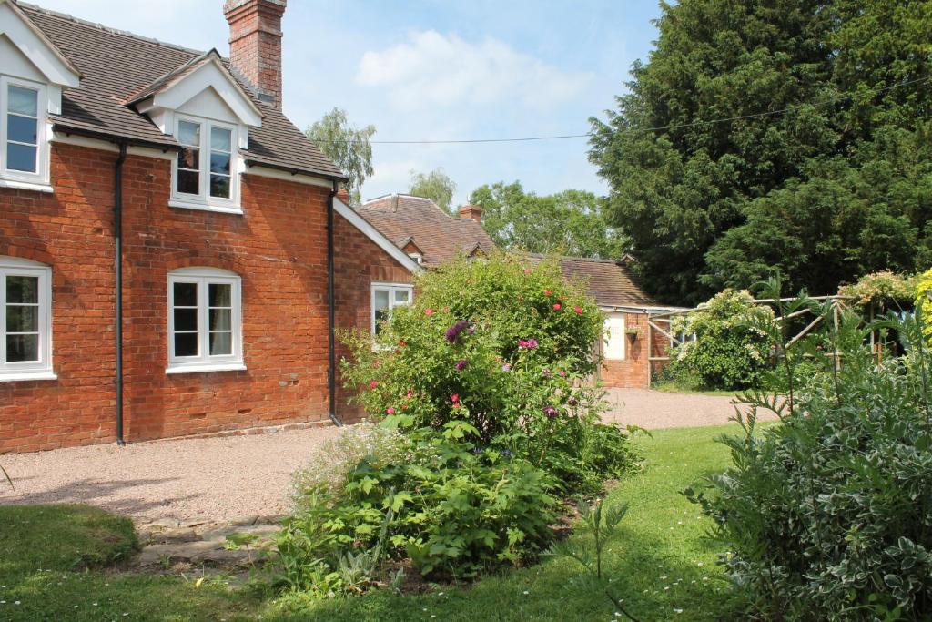 a brick house with a garden in front of it at West View Cottage in Worcester