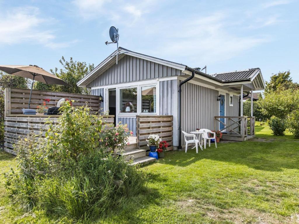 Bromölla的住宿－Holiday Home Täppan - SKO184 by Interhome，庭院内带桌椅的小屋