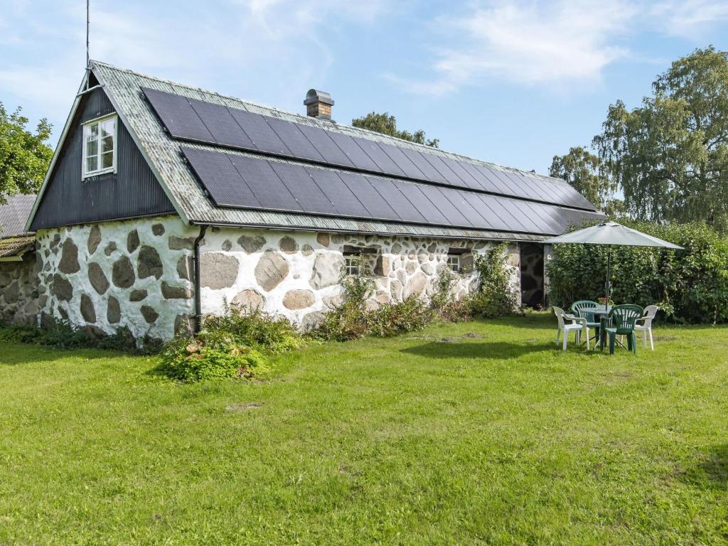 a stone house with solar panels on the roof at Holiday Home Västra Näs - B in Sölvesborg