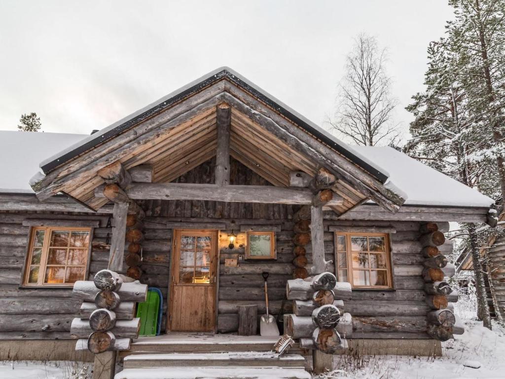 a log cabin in the snow with a front door at Holiday Home Operonmukka a 8 by Interhome in Levi