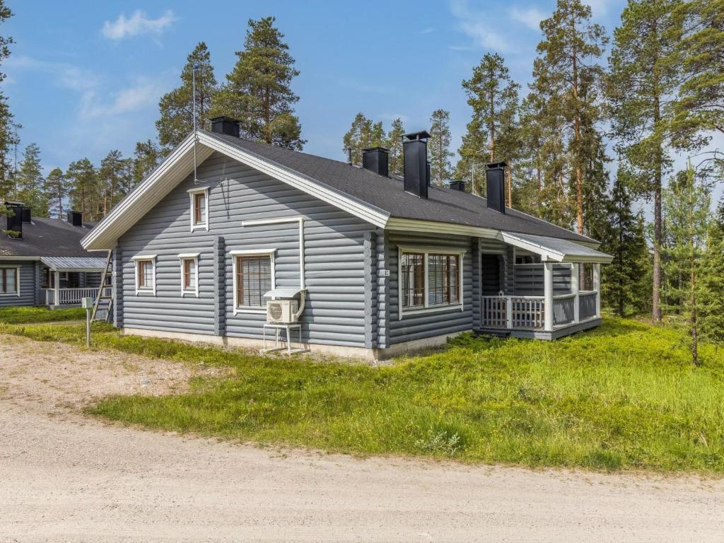 a gray house on the side of a road at Holiday Home Kaukonraitti 4 c 2 by Interhome in Ruka