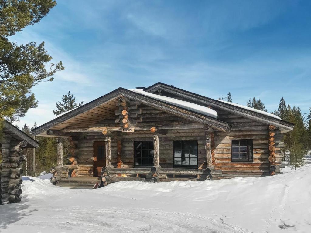 a log cabin in the snow at Holiday Home Tortone by Interhome in Ruka