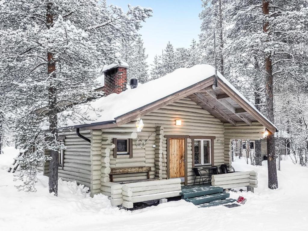 a cabin in the woods in the snow at Holiday Home Saivontupa by Interhome in Ylikyro