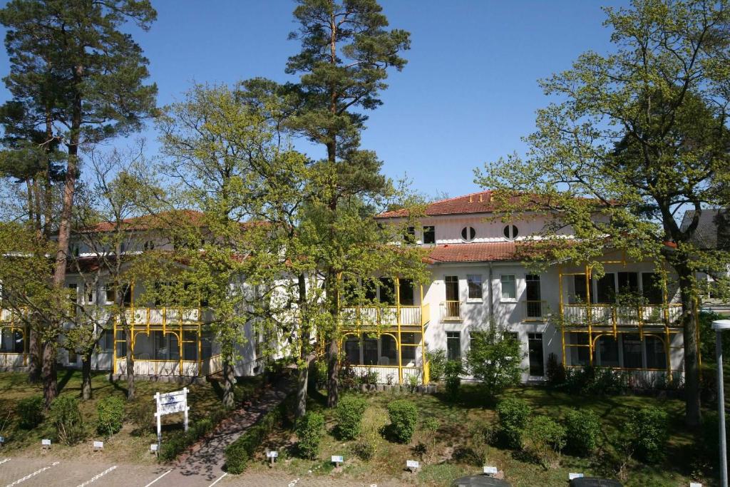 a large building with trees in front of it at Villa Störtebeker - FeWo 13 in Baabe