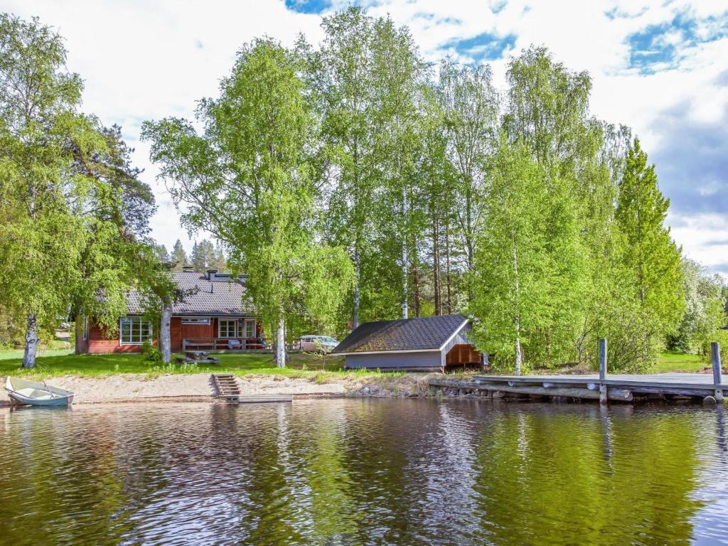 a house on the shore of a lake with a dock at Holiday Home Ettone by Interhome in Lipinlahti