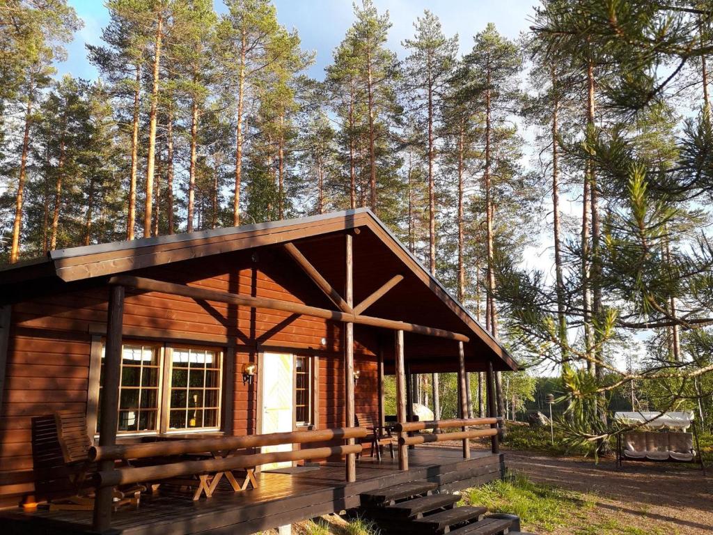 una cabaña en el bosque con árboles en el fondo en Holiday Home Aaretti by Interhome, en Arrakoski