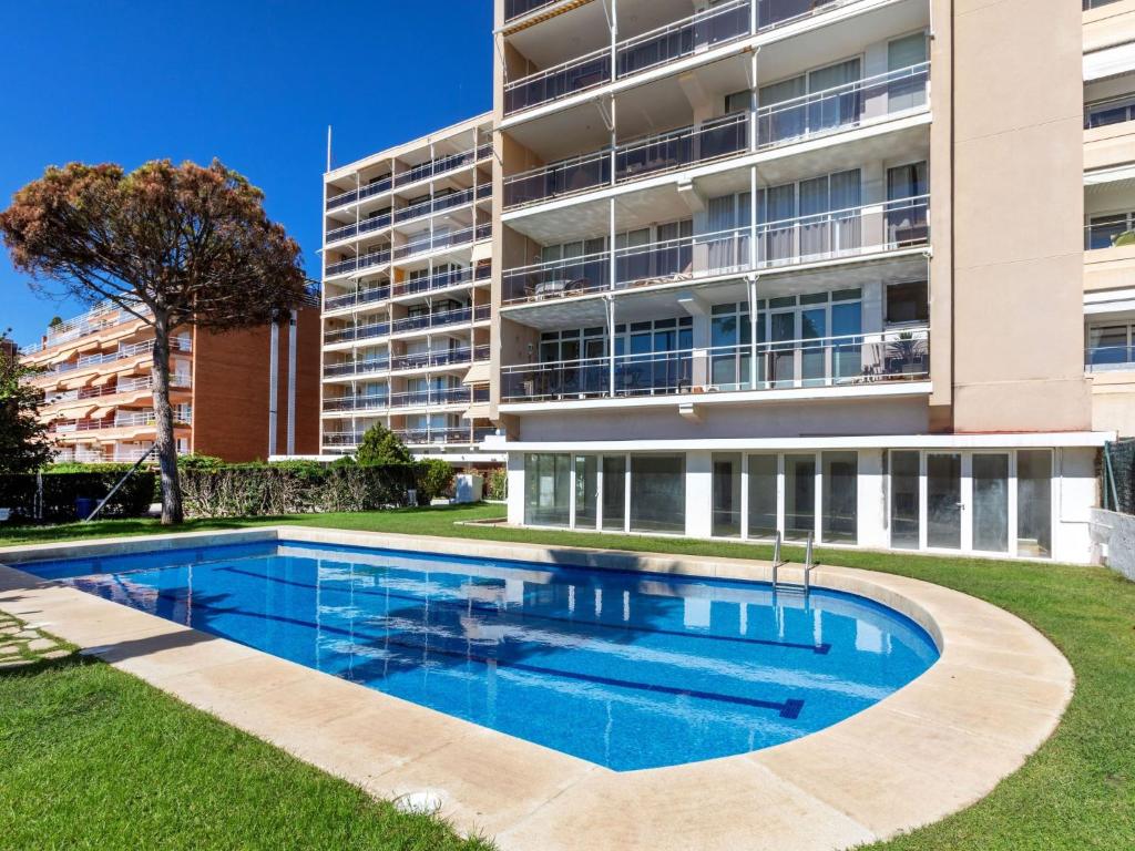 a swimming pool in front of a building at Apartment Clipper by Interhome in Sant Vicenç de Montalt