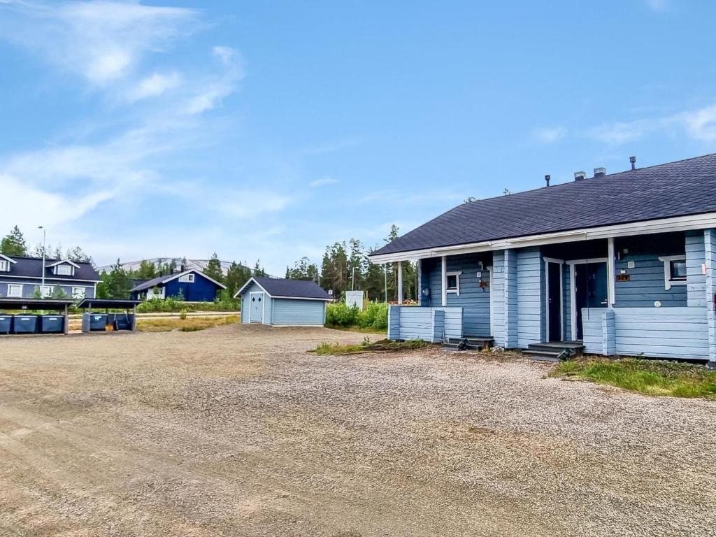 a house with a gravel driveway in front of it at Holiday Home Lähikaltio 329 by Interhome in Äkäslompolo