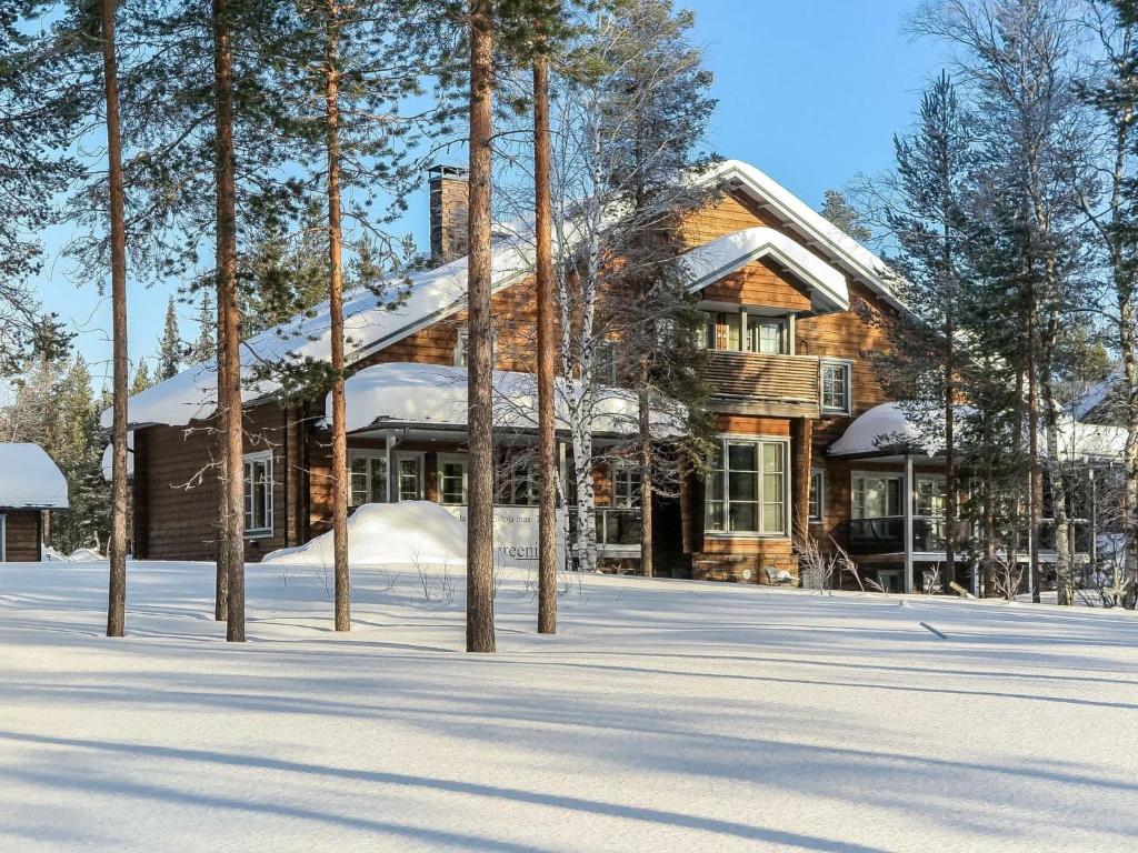 a log house in the snow with trees at Holiday Home Hiihtogreeni b by Interhome in Sirkka