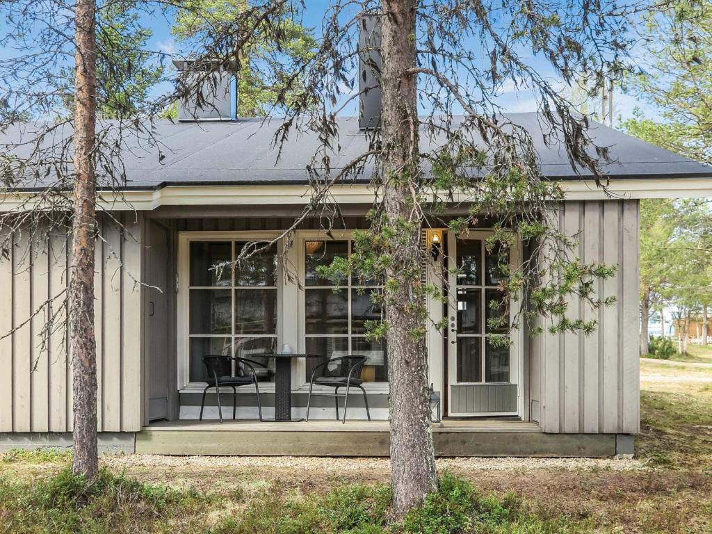 ein Haus mit einer abgeschirmten Veranda mit 2 Stühlen in der Unterkunft Holiday Home Riekonraito a1 by Interhome in Saariselkä