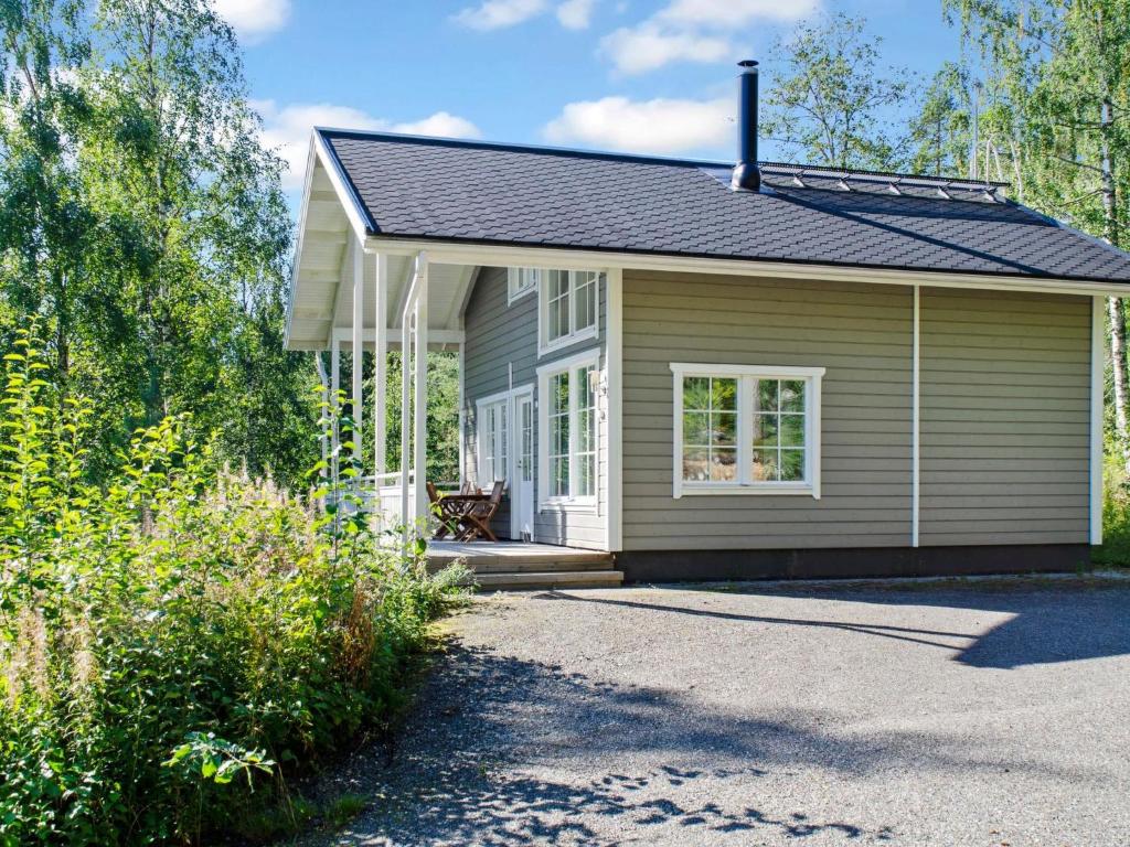 a small house with a gambrel roof at Holiday Home Kolin helmi 2 by Interhome in Kolinkylä