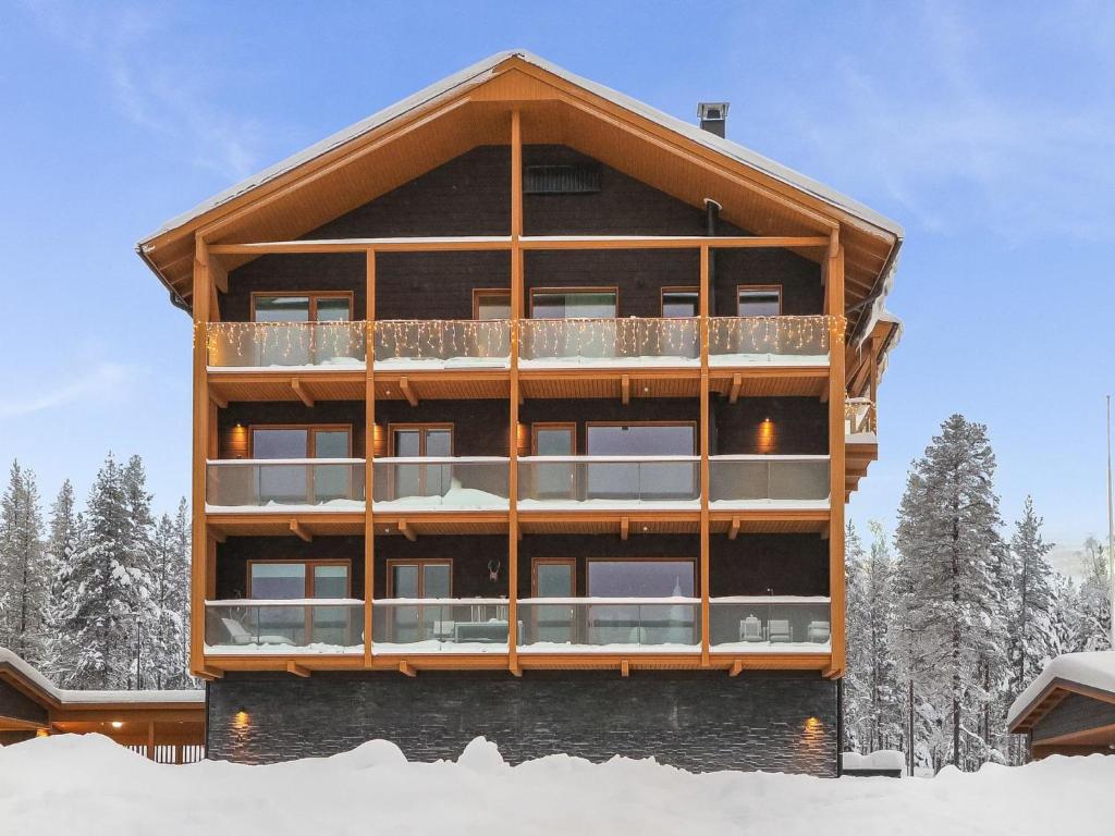 a large building with snow in front of it at Holiday Home Levi hillside by Interhome in Levi
