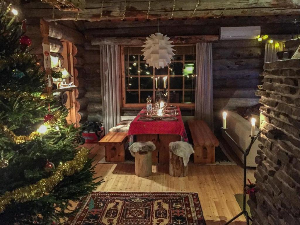 a room with a table with a christmas tree in it at Holiday Home Lomapata by Interhome in Nissi