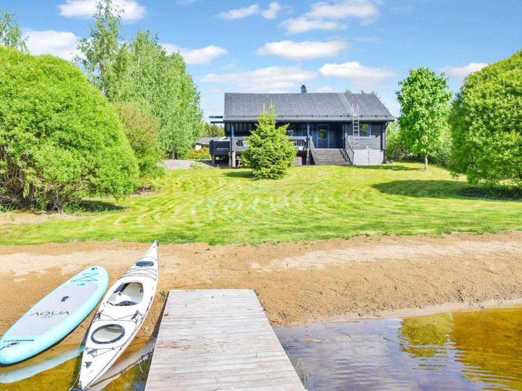 two kayaks are on a dock in front of a house at Holiday Home Nuppulanranta 14 by Interhome in Jämsä