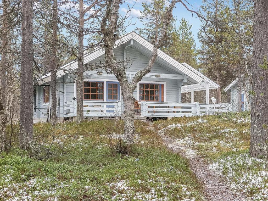 a white house in the middle of the woods at Holiday Home Keromaja by Interhome in Kakslauttanen