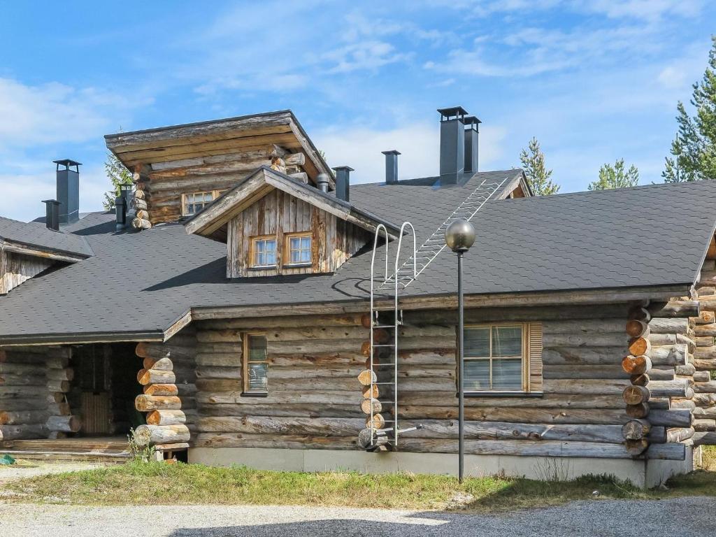 a log cabin with a roof on top of it at Holiday Home Tokkapirtti 3 by Interhome in Sirkka