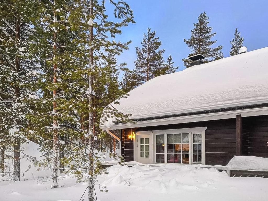 a house with snow on the roof at Holiday Home Kolonen by Interhome in Sirkka