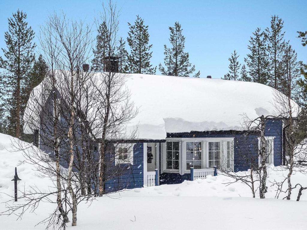 uma casa com um telhado coberto de neve em Holiday Home Sininen maja by Interhome em Saariselka