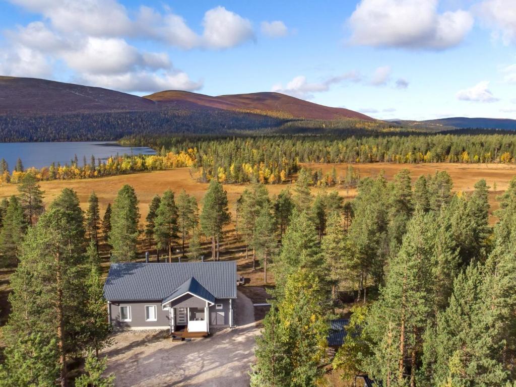 an aerial view of a house in a field with a lake at Holiday Home Villa taiga by Interhome in Ylikyro
