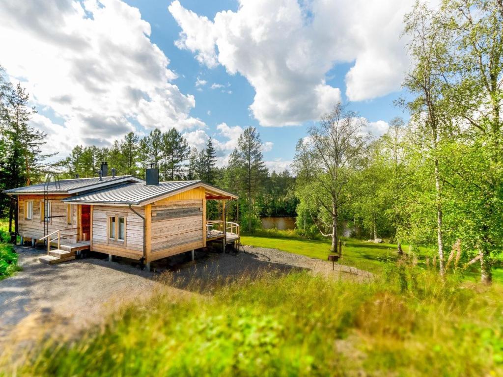 a cabin in the woods with a yard at Holiday Home Koivu by Interhome in Sonkajärvi