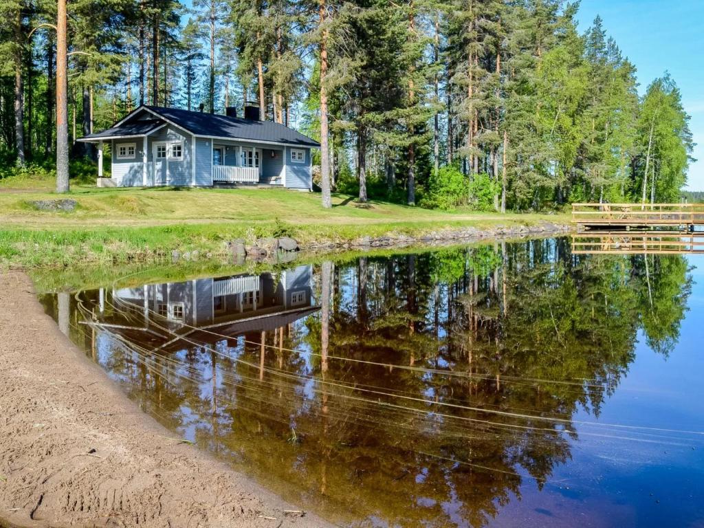 a house on the shore of a body of water at Holiday Home Piitterin saunatupa by Interhome in Juuka