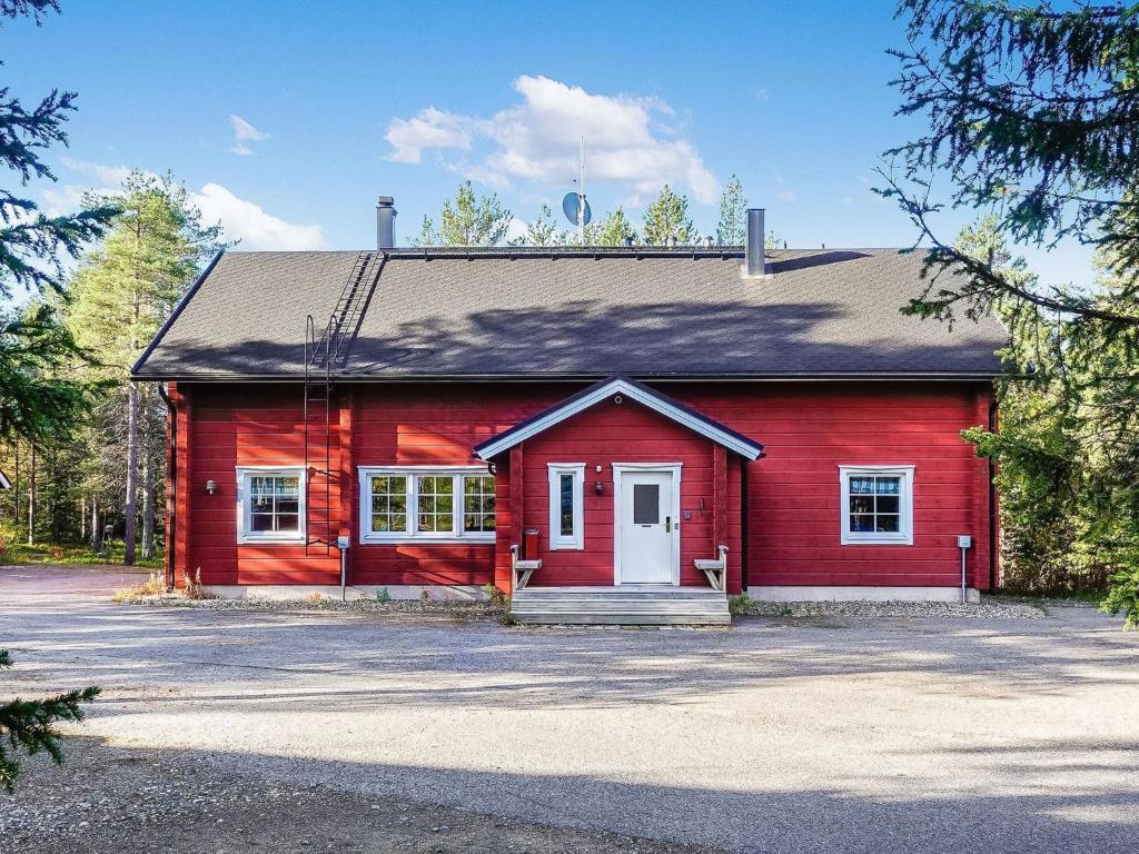 a red house with a driveway in front of it at Holiday Home Porukka 1 by Interhome in Sirkka
