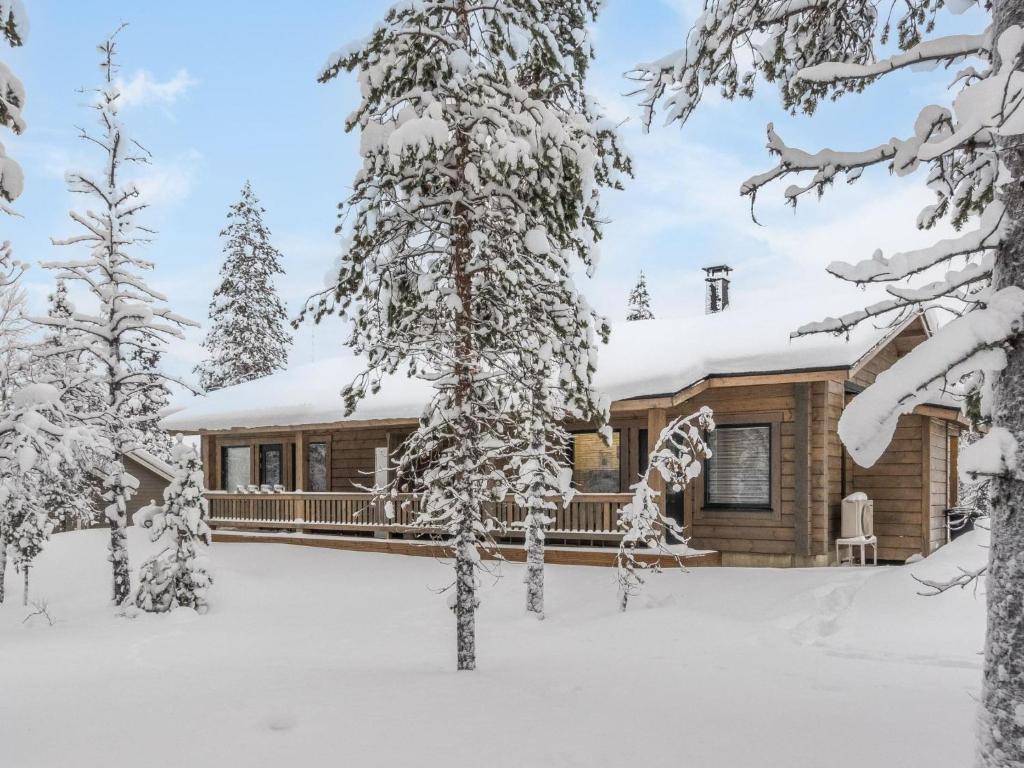 a log cabin in the snow with snow covered trees at Holiday Home Pehtoori b by Interhome in Saariselka
