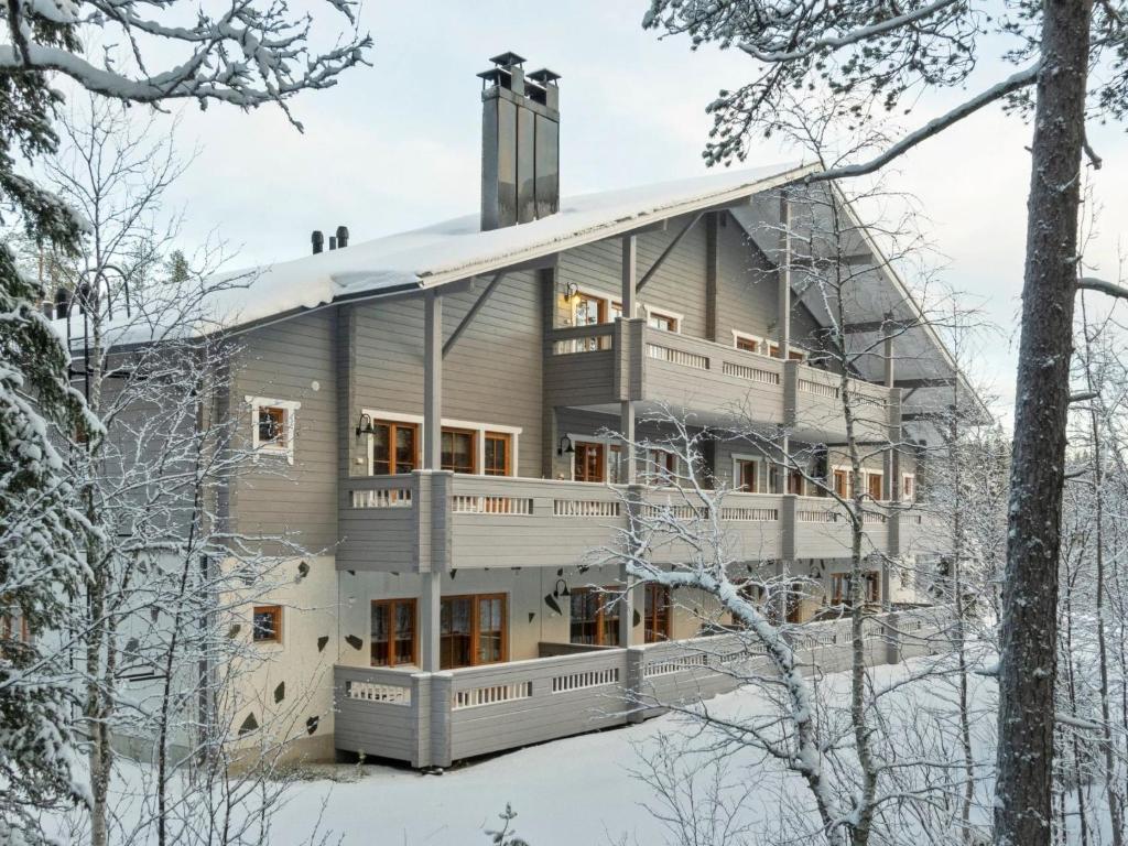 a large house in the snow with trees at Holiday Home Puolikuu a7 by Interhome in Sirkka