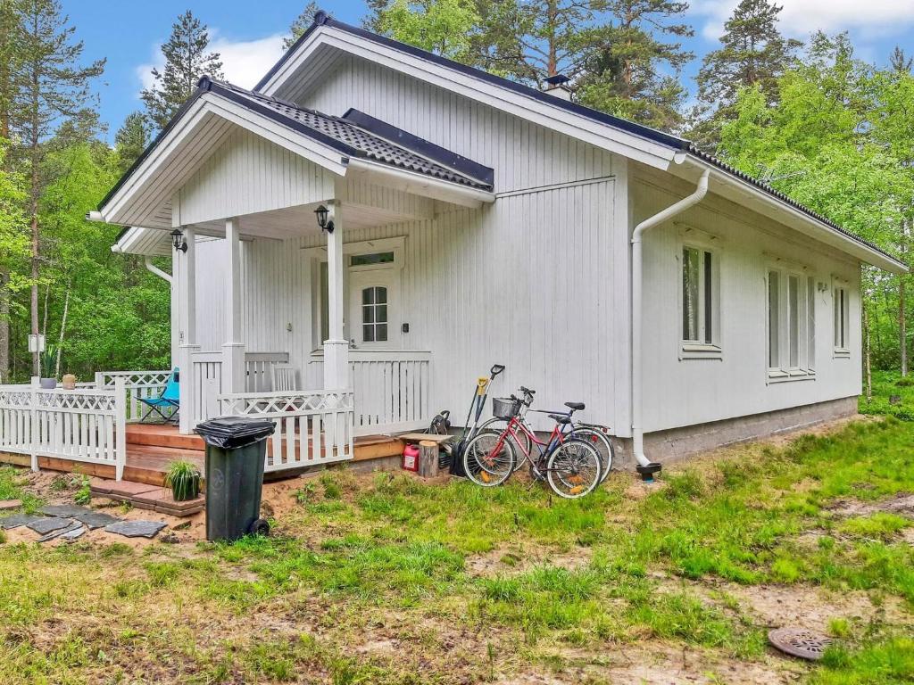 a white house with two bikes parked outside of it at Holiday Home Huvikumpu by Interhome in Hailuoto