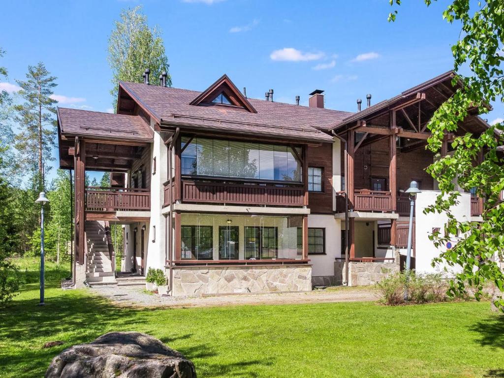 a large house with a gambrel roof at Holiday Home Point vale 3 by Interhome in Tahkovuori