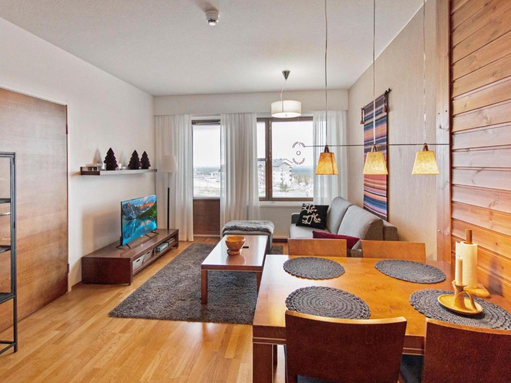 a living room with a dining room table and a couch at Holiday Home Ylläs chalets a104 by Interhome in Ylläsjärvi