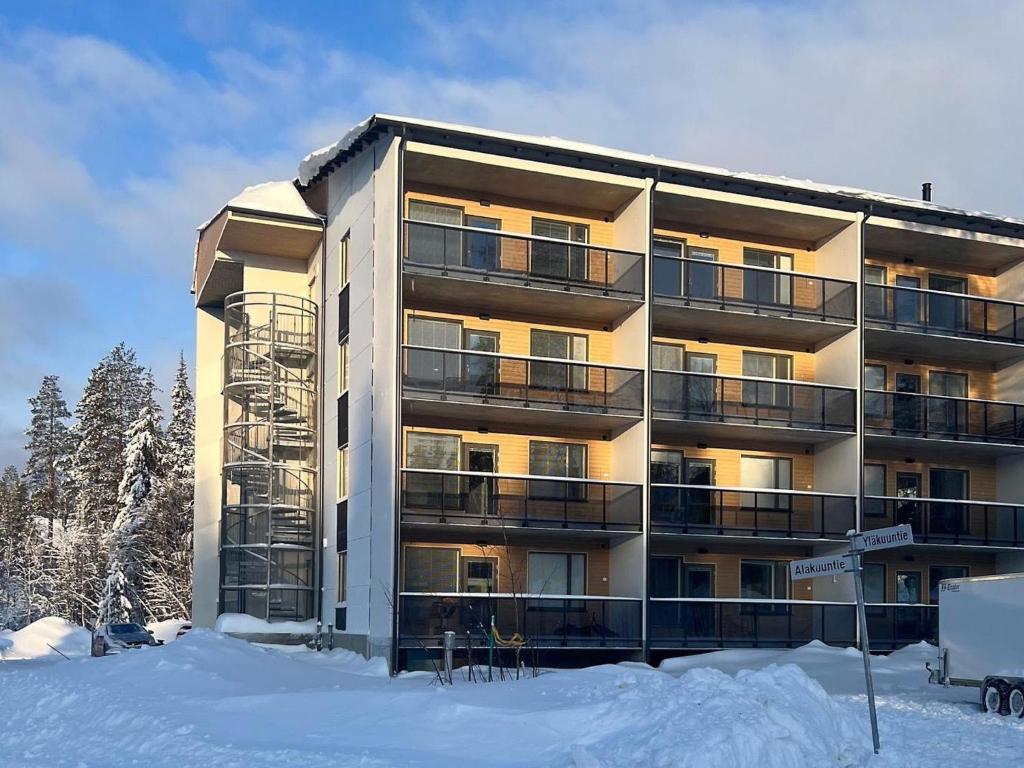 a building with snow in front of it at Holiday Home Alakuuntie 2- as-17 by Interhome in Sirkka